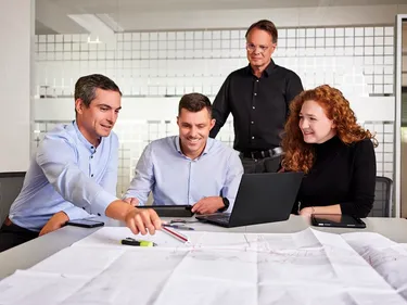 Mehrere Personen besprechen Baupläne